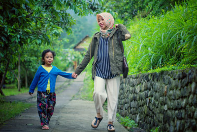 Full length of a smiling young couple standing outdoors