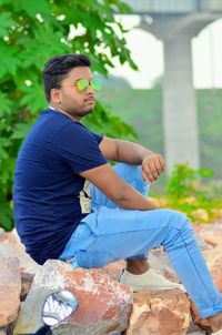 Side view of young man sitting outdoors of beach ....indain nature 