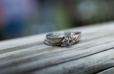 Close-up of wedding rings on wooden table