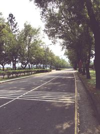 Road amidst trees against sky