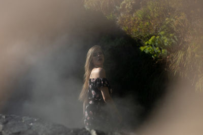 Portrait of woman standing in water