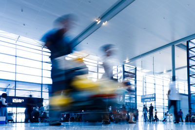 Blurred motion of people walking in bus