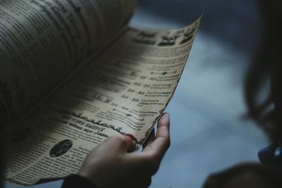 Midsection of person holding book