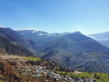 Scenic view of mountains against clear blue sky
