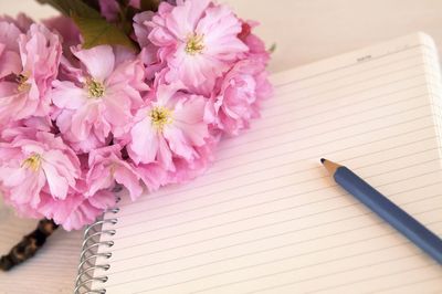 High angle view of bouquet and book on table