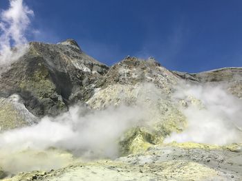 Low angle view of waterfall against sky