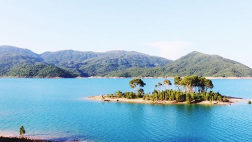 Scenic view of lake and mountains against sky