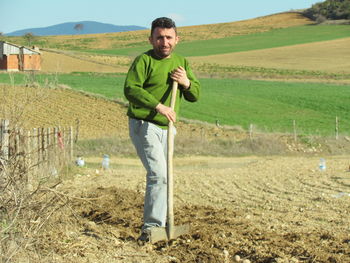 Portrait of smiling man standing in farm