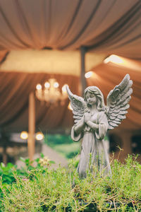 Statue of angel on grass