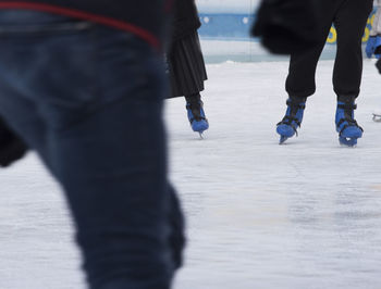 Low section of people ice skating