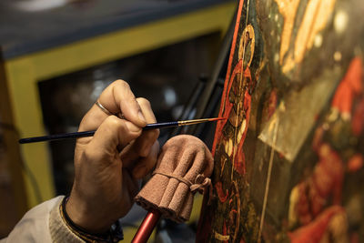 Midsection of woman restauring an ancient picture