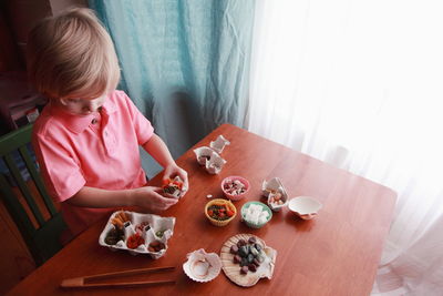 Rear view of woman sitting on chair