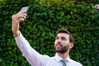 Portrait of young man using mobile phone