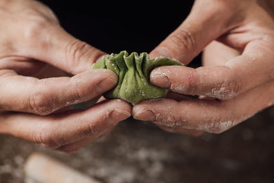 Cropped hands making dumplings