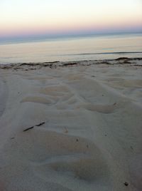 Scenic view of beach against sky during sunset