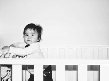 Portrait of cute boy against railing