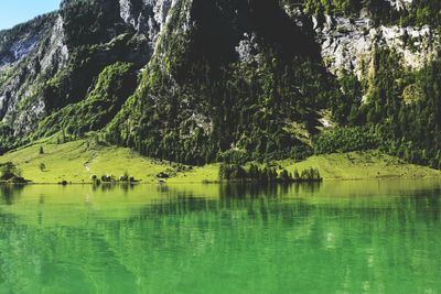 Scenic view of lake by mountain against sky