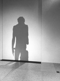 Shadow of man standing on floor