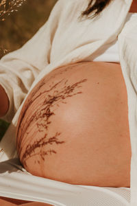 Midsection of woman holding pumpkin