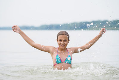 Portrait of smiling young girl in sea
