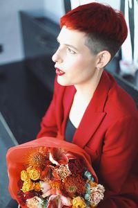 Side view of young woman having food