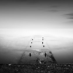 Pier amidst sea against sky during foggy weather