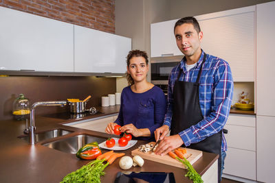 Young man preparing food on table at home