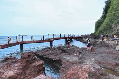 People on beach against sky