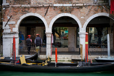 Gondoliers waiting next to their gondolas 