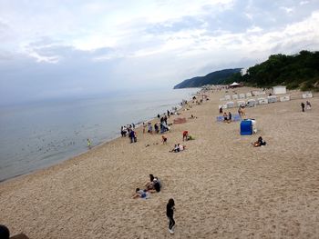 People on beach against sky