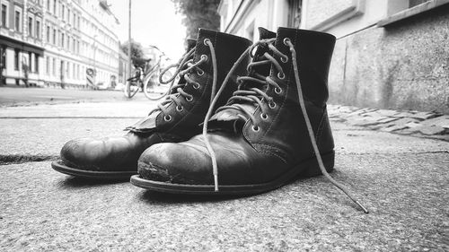 Close-up of shoes on street