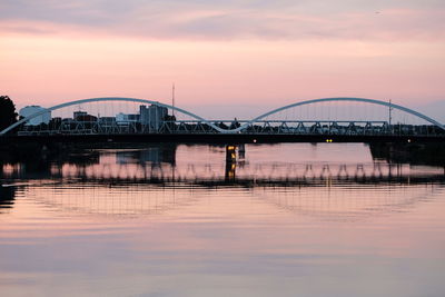 Bridge over river against cloudy sky