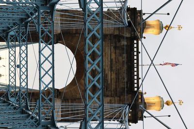 Low angle view of crane against building