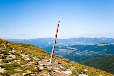 Scenic view of mountains against blue sky