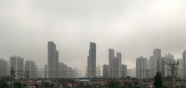 Modern buildings in city against sky