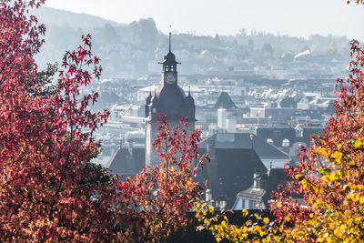 Panoramic view of buildings and trees against sky