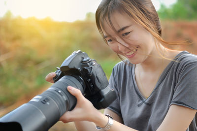 Smiling woman holding camera