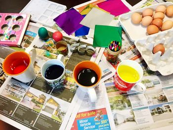 High angle view of easter eggs with craft products on table