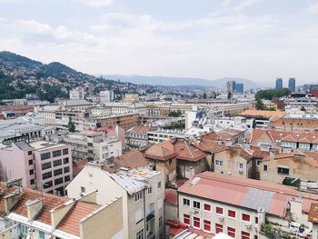 High angle view of houses in city against sky