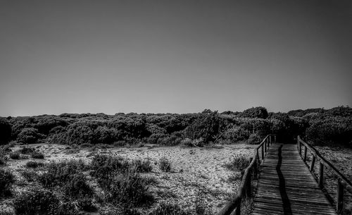 Footbridge against clear sky