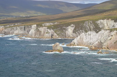 Scenic view of sea and mountains against sky