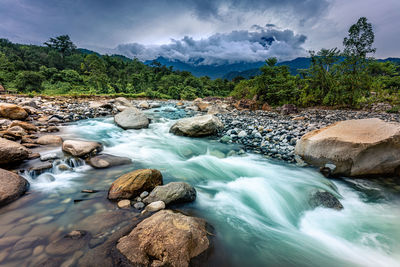 Scenic view of waterfall against sky