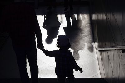 Silhouette people standing in corridor