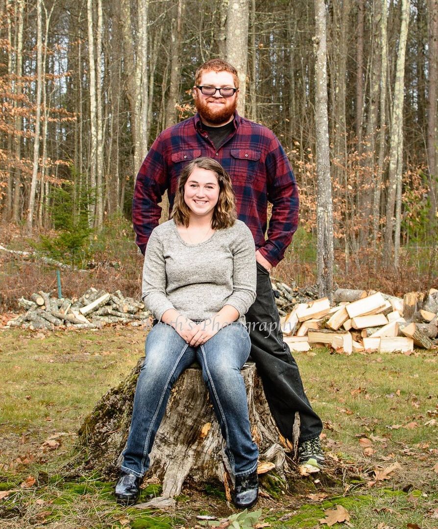 looking at camera, portrait, heterosexual couple, two people, forest, smiling, togetherness, adult, woodland, couple - relationship, full length, day, outdoors, adults only, men, people, tree, sitting, autumn, happiness, nature, women, industry, young adult, warm clothing
