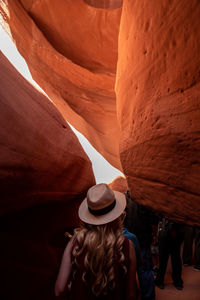 Rear view of woman walking in cave