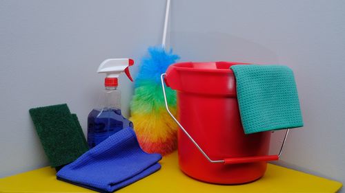 Various bottles in container on shelf