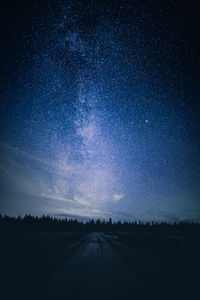 Scenic view of road against sky at night