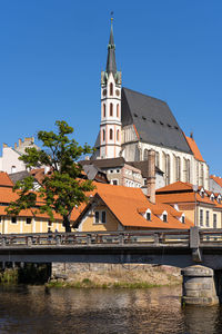 St. vitus church in cesky krumlov, czech republic seen from vltava river waterfront