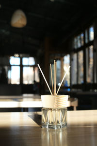 Close-up of  incense sticks on table in restaurant