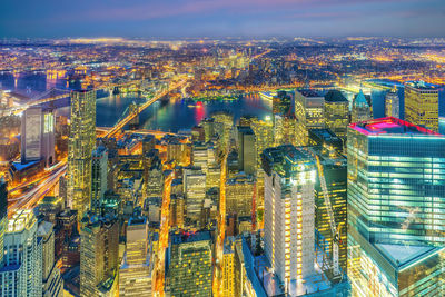 Aerial view of city lit up at night